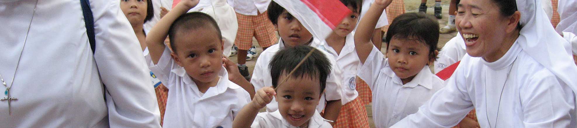 children in Asia waving flags