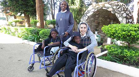 nuns with children in wheelchairs