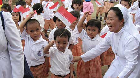 children in Asia waving flags