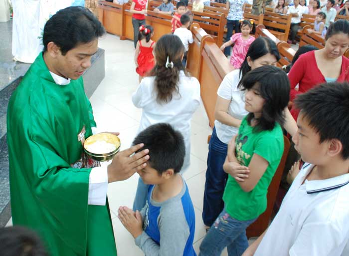child getting baptized in Asia