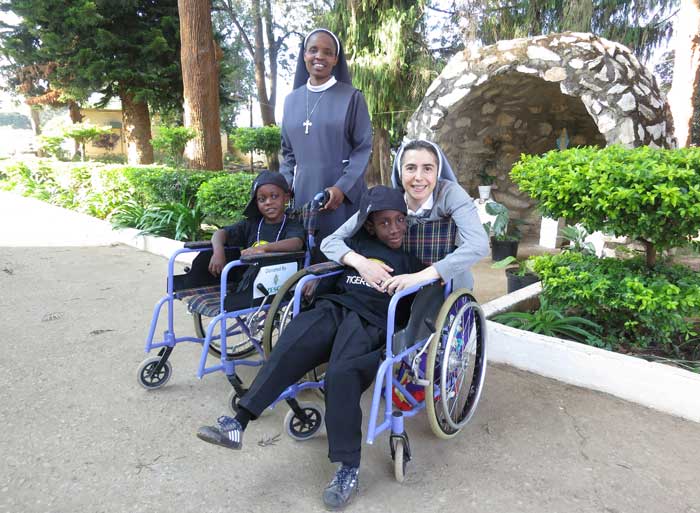 nuns with children in wheelchairs