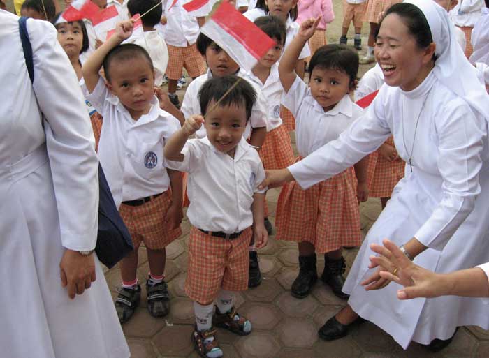 children in Asia waving flags