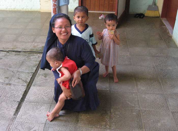 A nun with children in Asia